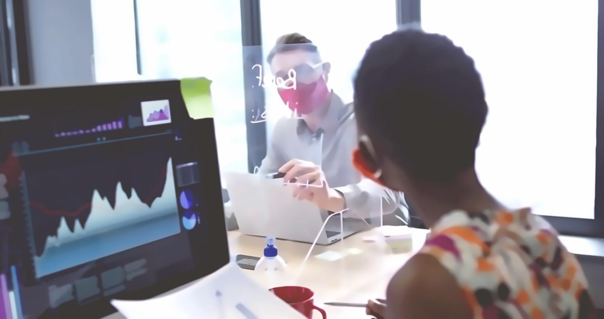Students collaborating on blockchain development project using multiple monitors